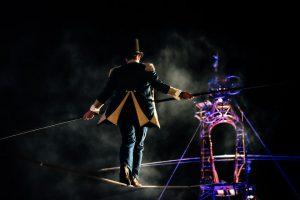 Circus ringmaster ascends a highwire