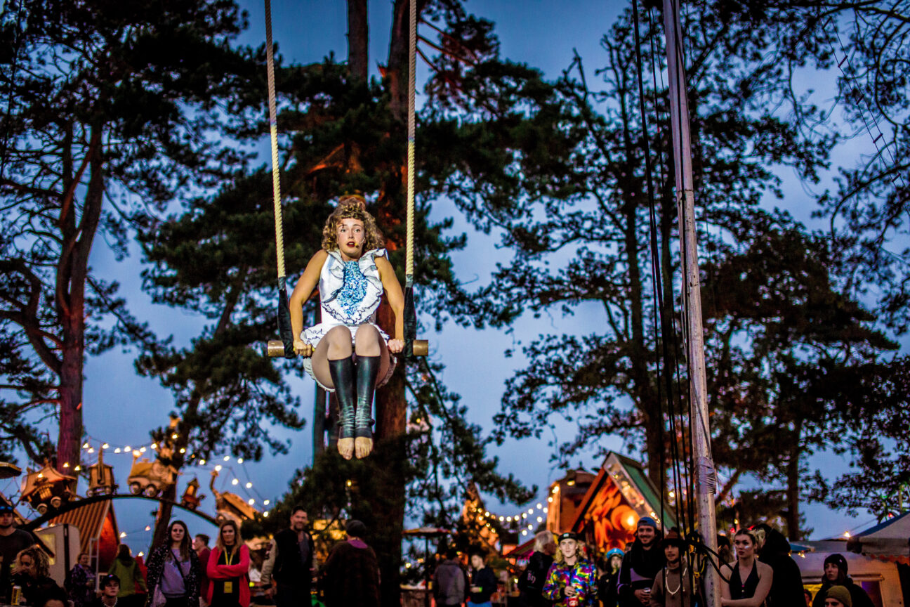 Tilly Performing at Camp Bestival Dorset on her trapeze at dusk