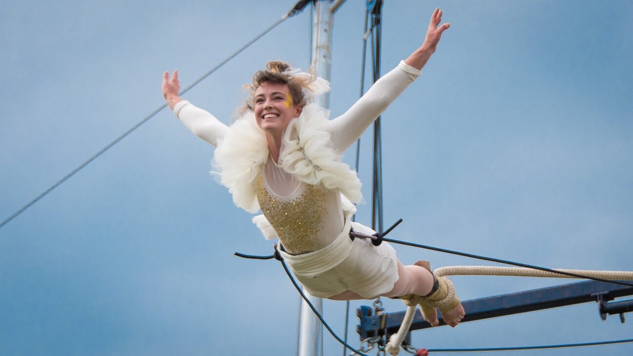 Tilly swings in the air from her trapeze at Godiva Festival