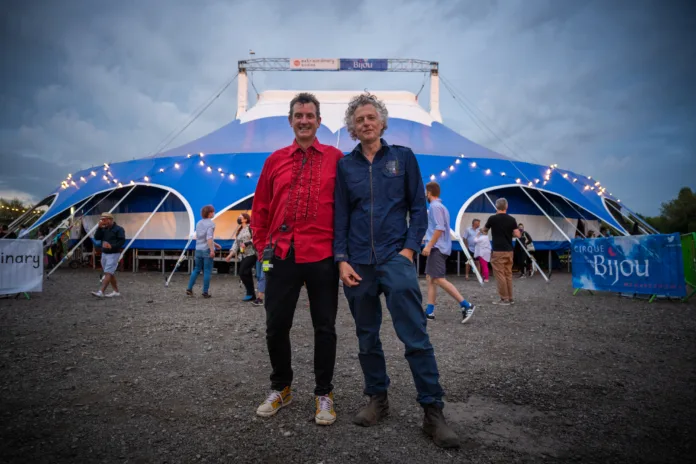 Billy and Julian, artistic directors for Cirque Bijou stand in front of a big top