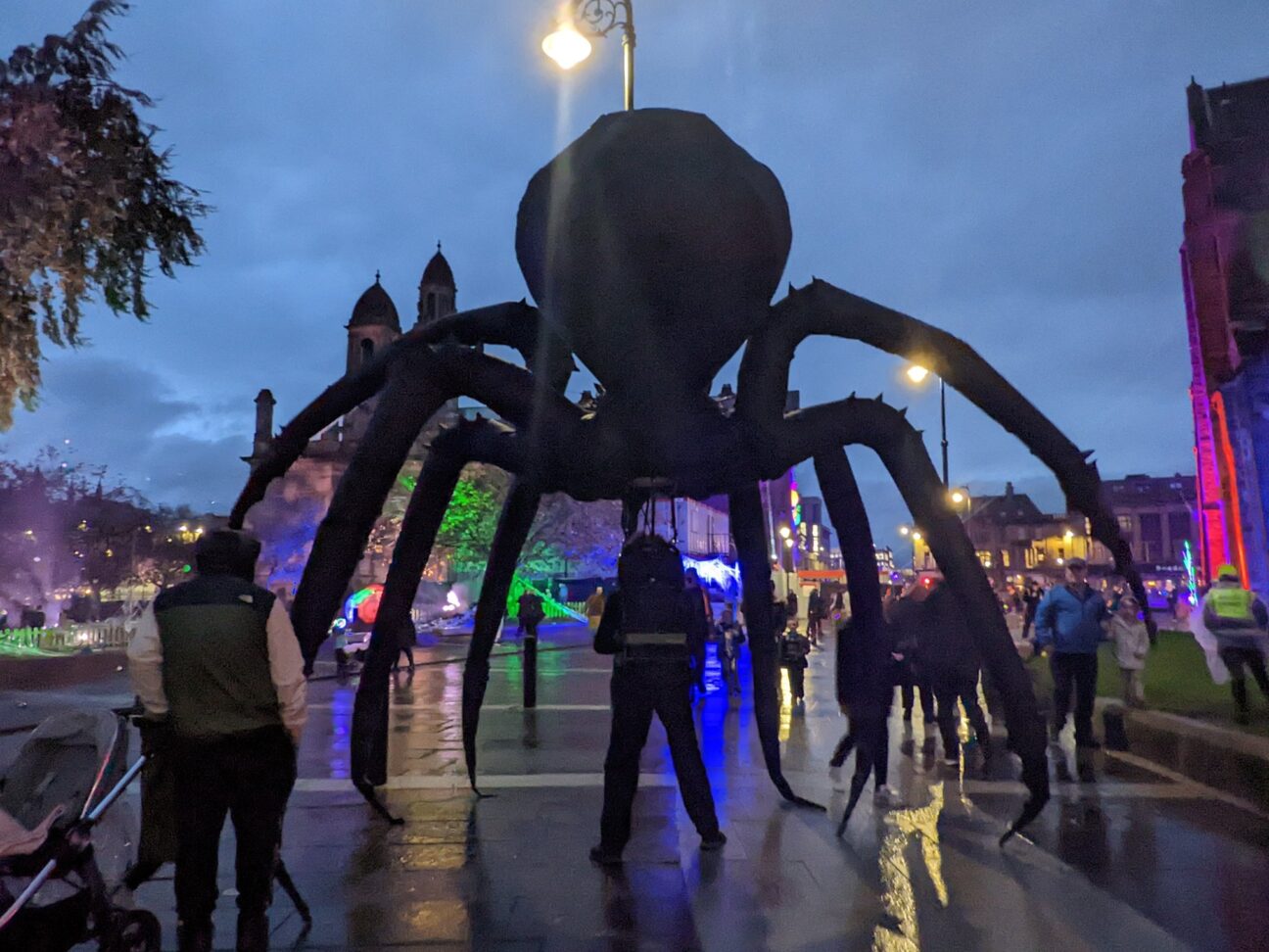 Large spider puppet parading the streets at the Paisley Halloween Festival