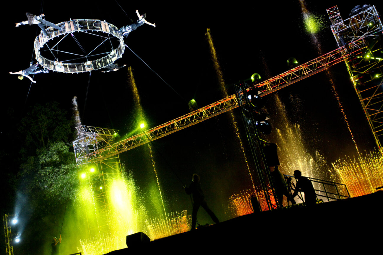 A shot of our aerial crane and truss set up for the performance to begin, with colourful lights lighting the night sky - Goodwood FOS 2013