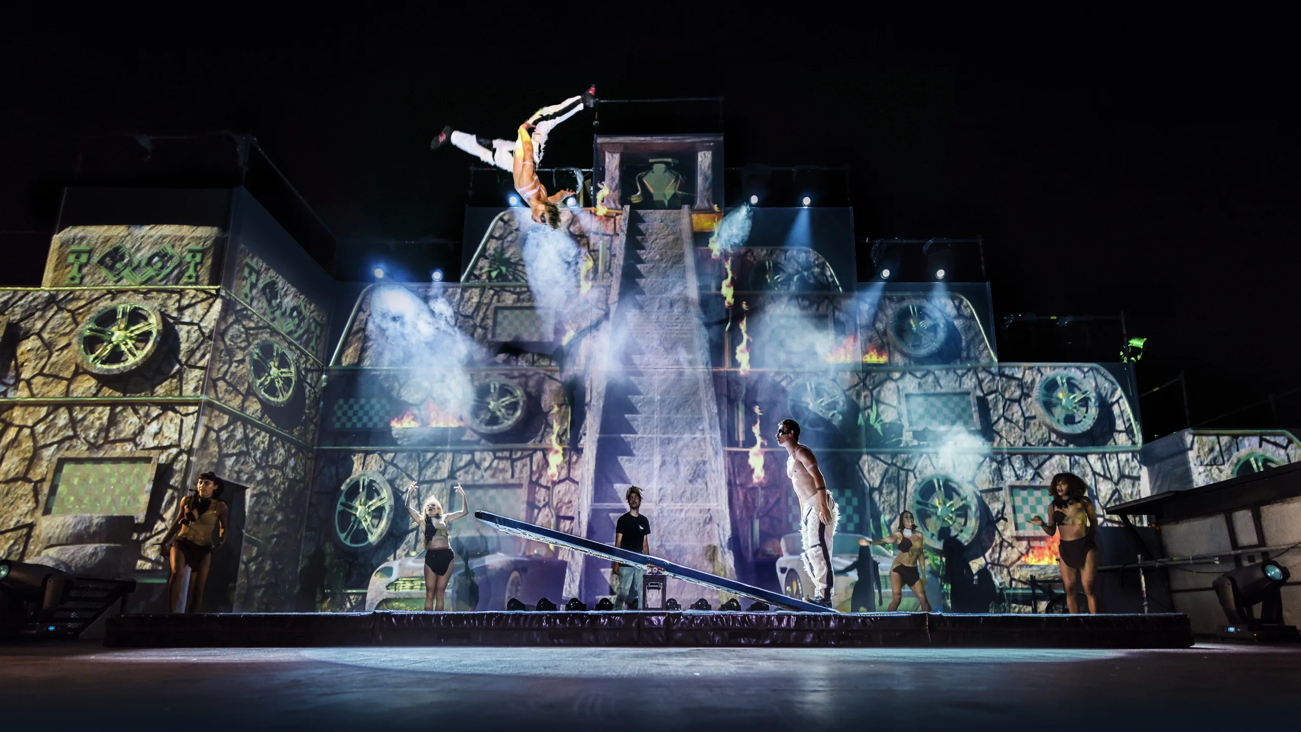 Teeterboard artists perform infront of a projected screen of a Mayan temple. Performing at the Goodwood Festival of Speed Driver's Ball, 2018