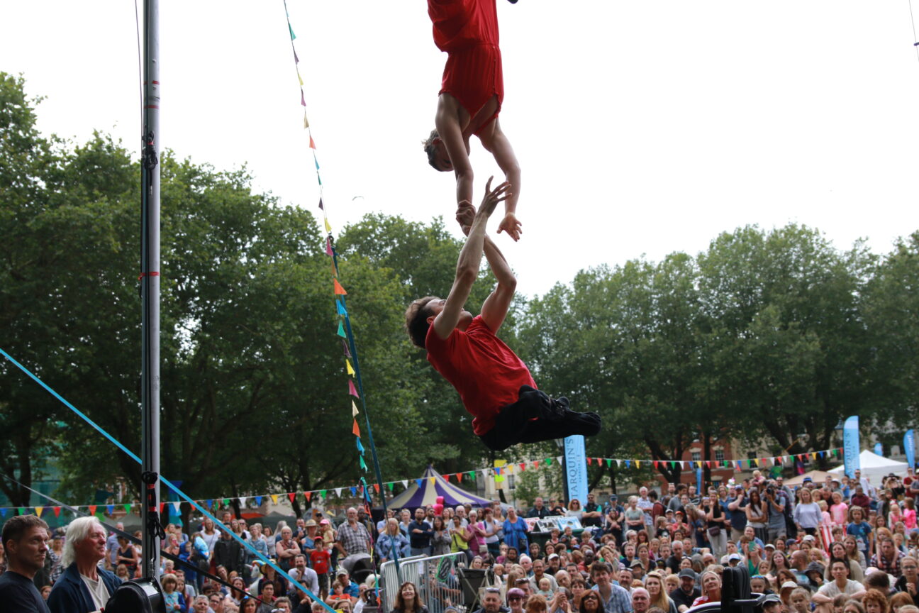 Bristol Harbourside Festival- Jonny and Tilly holding hands during their trapeze duet.