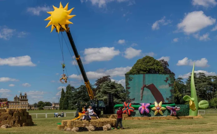 Our set up at Countryfile Live - a screen is set up showing an aerialist, with her suspended in the foreground from a crane with a blow up sun at the top