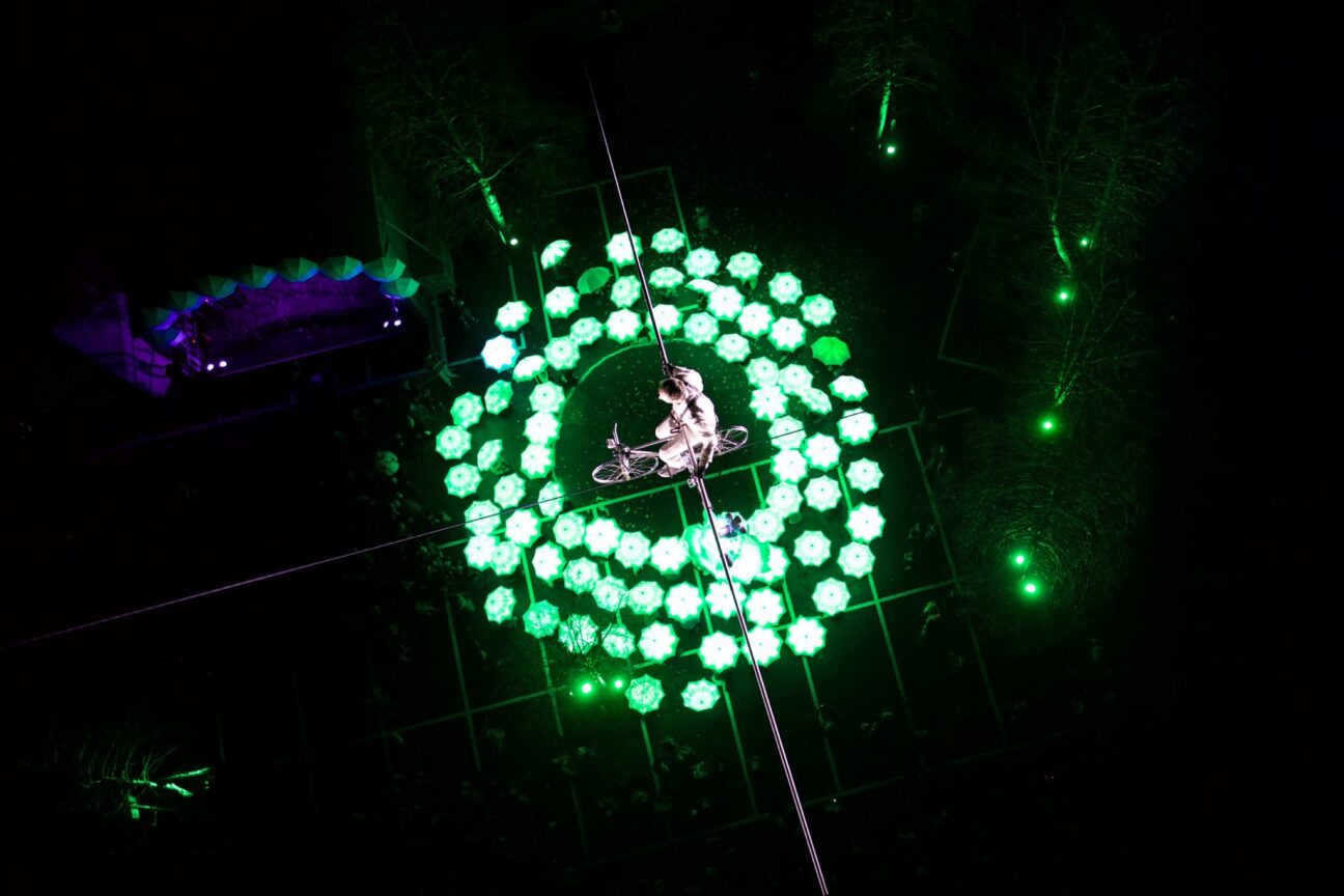 Bristol opens European Green Capital year - Jade Kindar-Martin cycles on high wire 100ft above the city as volunteers form green circle below