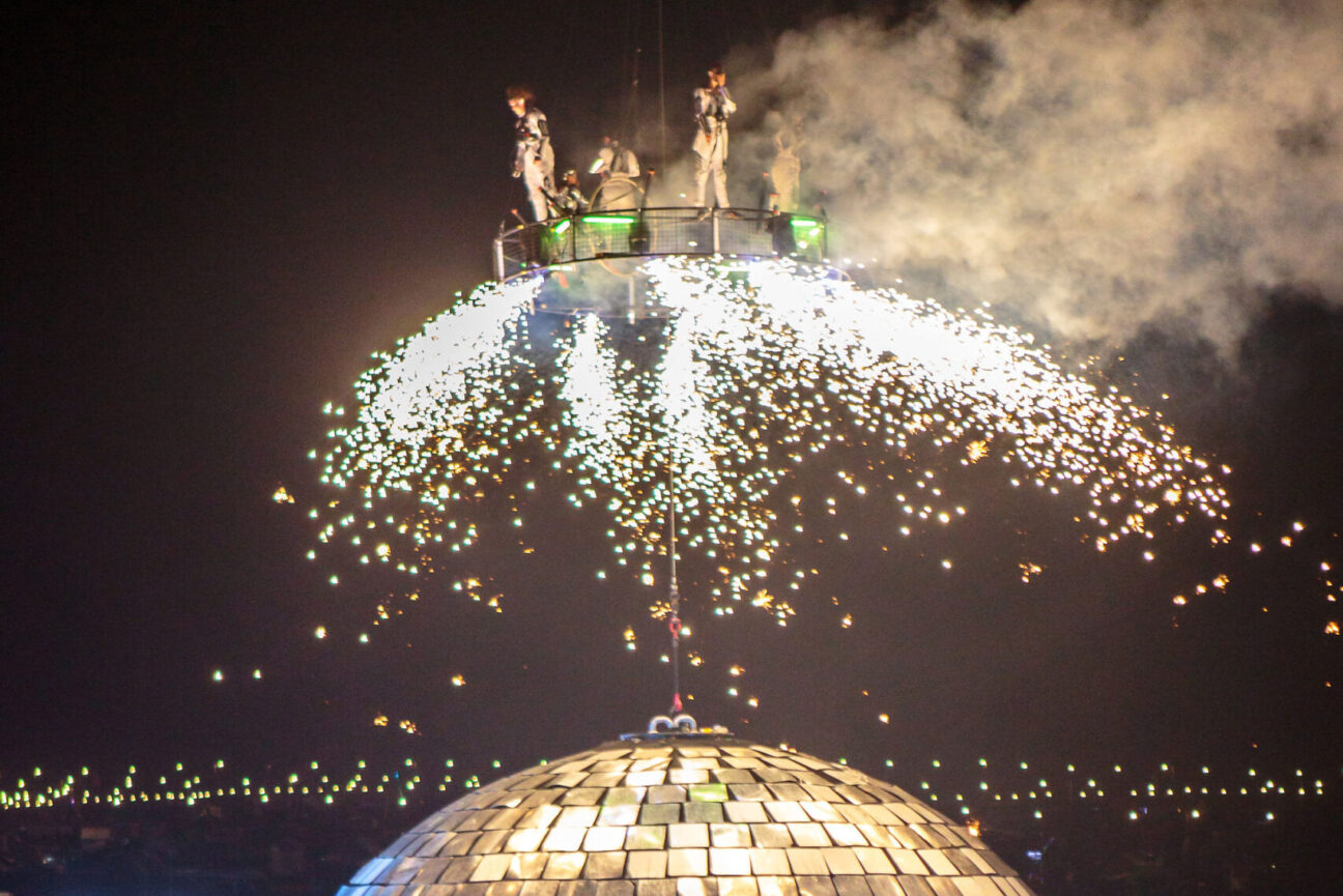 Pyrotechnics above the disco ball on the aerial carousel.