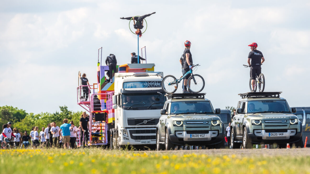 Rehearsals take place for the jubilee pageant - landrovers with stunt cyclists atop, a performer on a lollipop hoop and various others