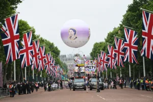 Cirque Bijou's parade at the Queen's Platinum Jubilee Pageant, coming towards the camera through an avenue of union jack flags