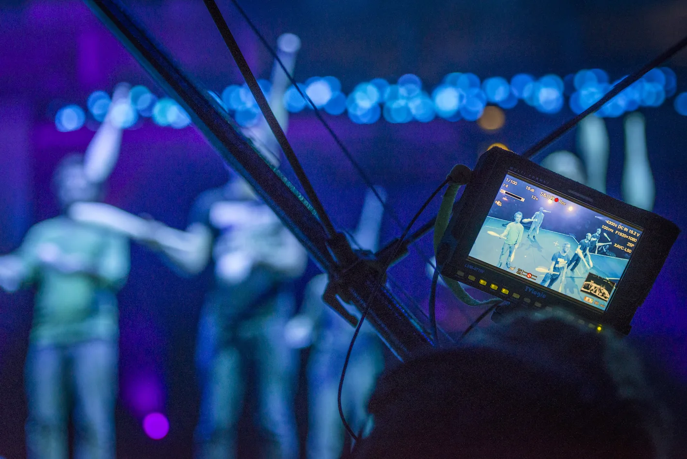 Screen shows tech rehearsal for circus show