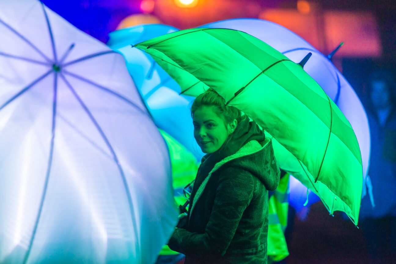 Close up shot of one of our umbrella performers, smiling and looking at camera