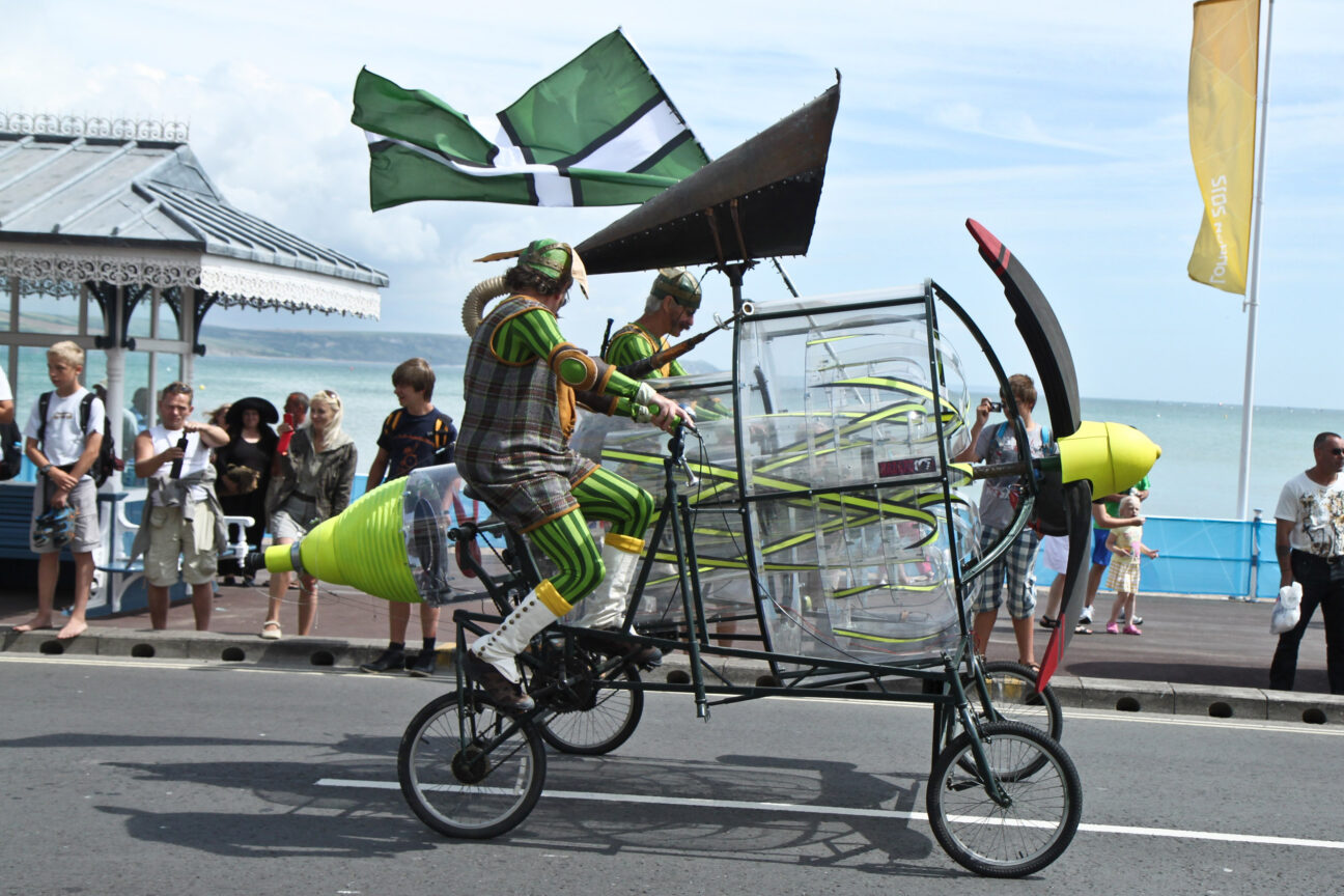 Performers race along the streets of Weymouth, on a contraption made to highlight and harness the wind - for our Battle of the Winds celebration for the opening of Olympic sailing at Weymouth 2012