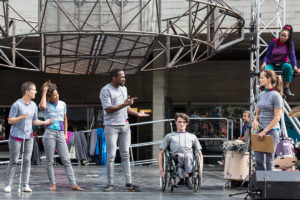 Extraordinary Bodies cast Alfa Marks, David Ellington and Jonny Leitch in What Am I Worth? National Theatre River Stage. Image Rob Harris. 