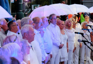 A choir complete with LED umbrellas perform. Portolan, Sunderland Tall Ships, Cirque Bijou. Image Sunderland City Council.