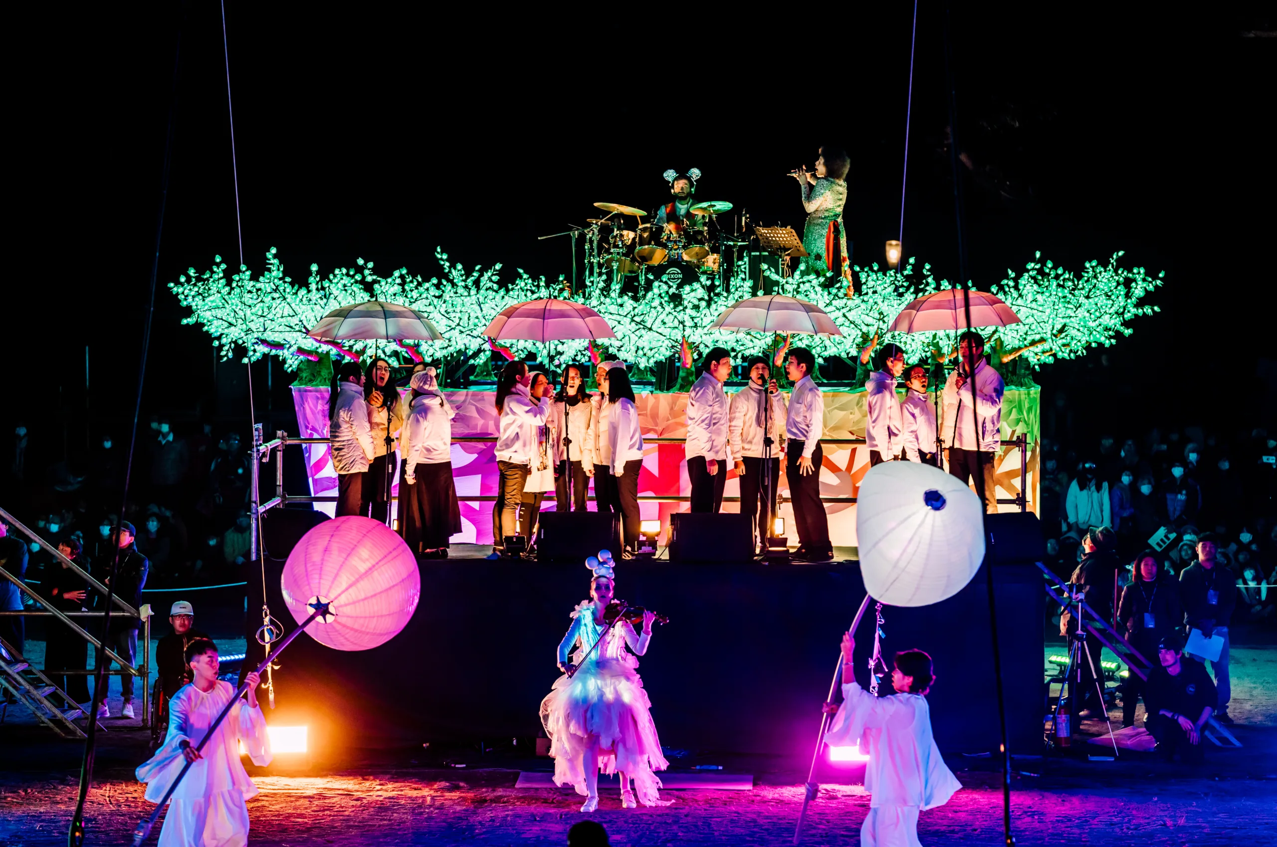 Shot of lantern performers and an illuminated and decorated stage with musicians on - Taiwan Lantern Festival 2019