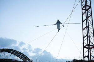 A shot from below showing Chris Bullzini walking along the wire. Portolan, Sunderland Tall Ships, Cirque Bijou. Image Dan Prince. 