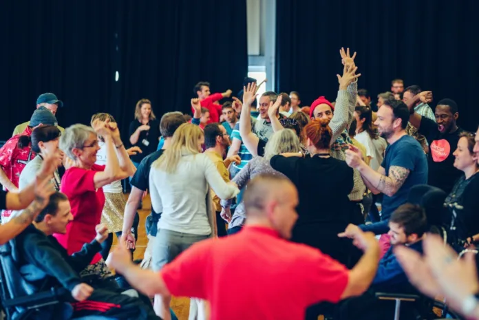 Extraordinary Bodies team celebrate in a big colourful dance